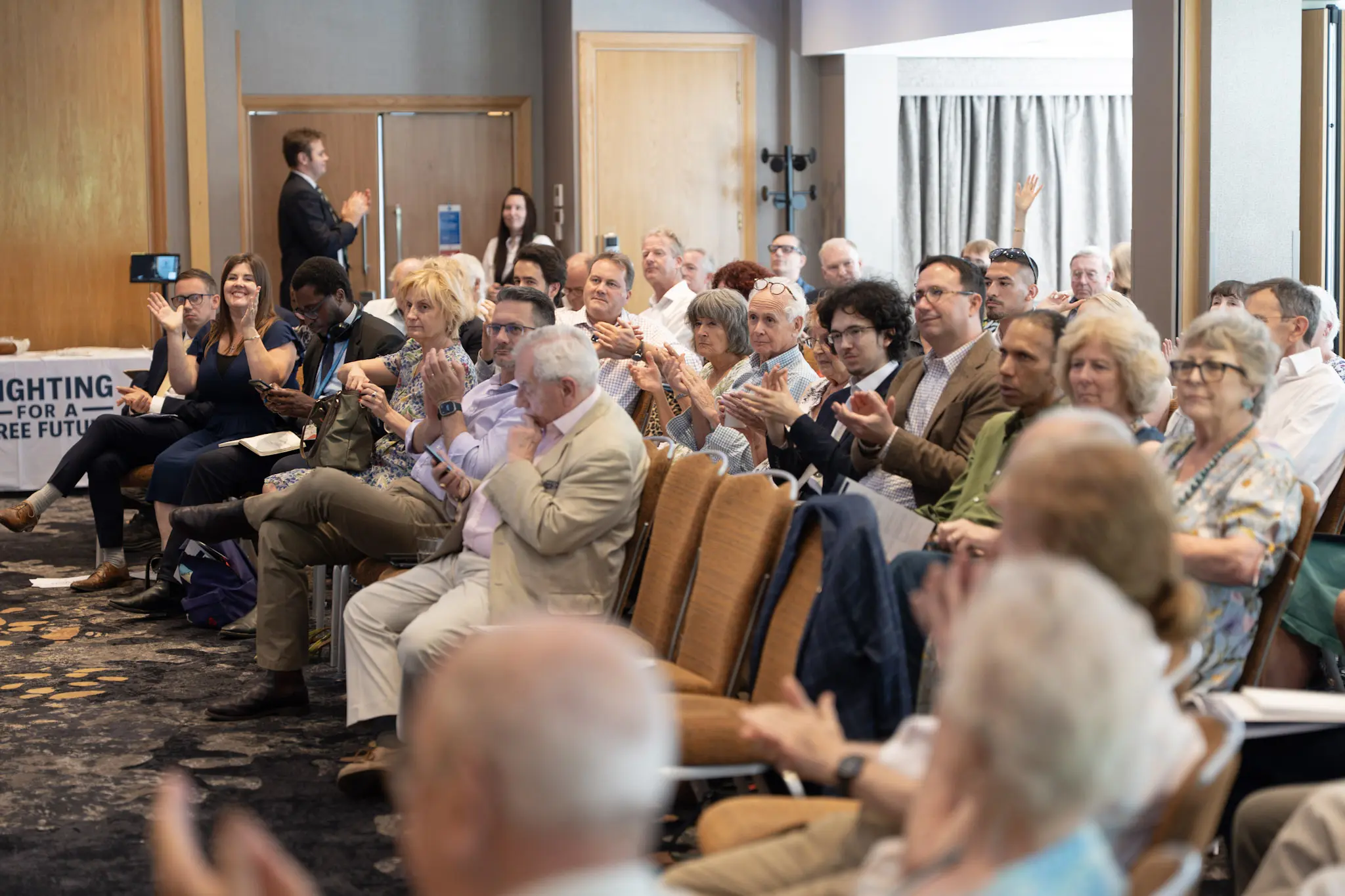 Seated delegates listening to a session at the Disraeli Conference
