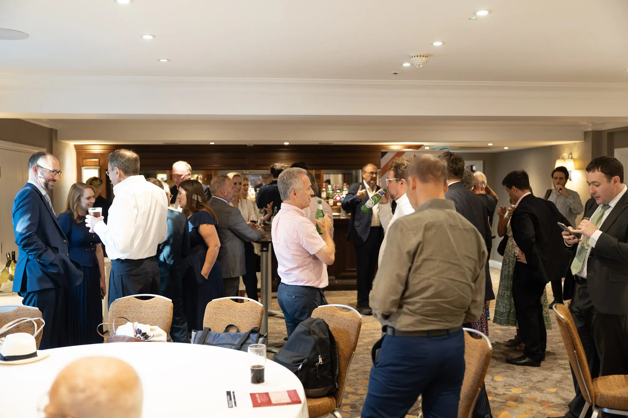 Delegates talking in small groups during a conference networking reception